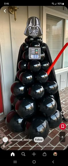 a star wars christmas tree made out of bowling balls and darth vader helmet