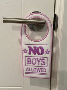 a door handle with a no boys allowed sign hanging on the side of a door