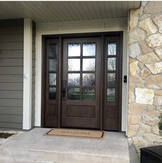 the front door is brown and has two sidelights