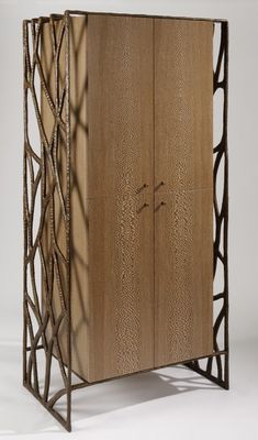 a tall wooden cabinet with an intricate design