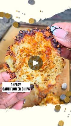 two hands holding up a cheesy cauliflower chips