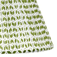 a green and white lamp shade with leaves on it