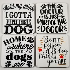 four coasters with black and white lettering that say, home is where the dogs are