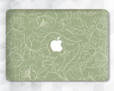 an apple logo on the side of a green and white flowered background with leaves