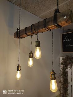 several light bulbs hanging from a wooden beam