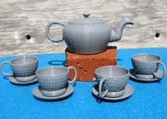 there is a tea set with cups and saucers