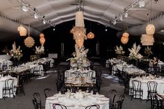 tables and chairs are set up in a tented area for a formal dinner or function