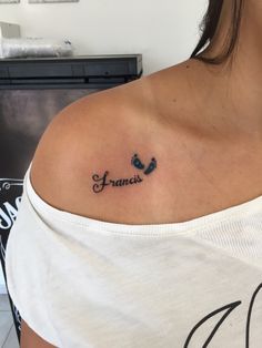 a woman with a small tattoo on her shoulder that says, fannie and the word'fannie'in cursive font