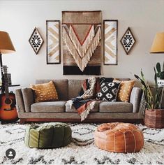 a living room filled with lots of furniture and decor on top of a white rug