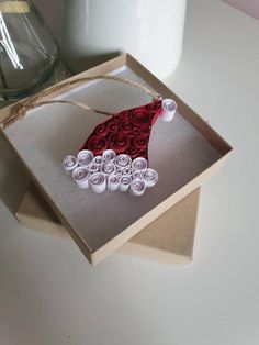 an ornament made out of rolled paper in a box