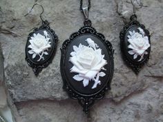 For sale are beautiful flawless (white rose with a single bud on a striking black background) cameo pendant necklace and matching earrings set. The cameos are gorgeous, very detailed. I can make any cameo in my store into this pretty set, so feel free to browse, message me and I will be glad to set up a custom listing. They are offered at a reasonable price, make perfect gifts, and are wonderful quality The cameos are set in black enamel settings (lead and nickel free), please see the photo for Black Rose Jewelry, Cameo Pendant Necklace, Cameo Earrings, Cameo Necklace, Rose Jewelry, Cameo Pendant, Necklace And Earrings, Black Enamel, Black Rose