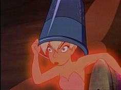 a naked woman with a bucket on her head in front of a red light and a barrel