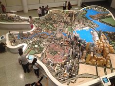 people looking at a model of a city