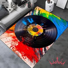 a living room area rug with a vinyl record on the floor and colorful paint splatters all over it