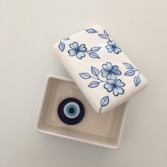 two blue and white vases with an eye on them