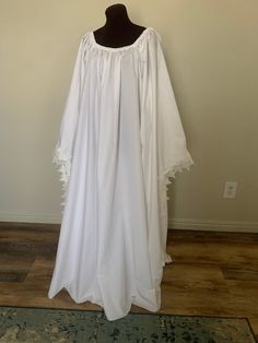 Hello!  I am currently doing sales outside of etsy.  Please contact desree10@yahoo.com and I can accept cards thru paypal and venmo for a $10 discount of the listed price. Thank you! This romantic chemise is the perfect under dress for any renaissance ensemble!  The ultra-full gown is an A-line design that reduces bulk at the top but is full enough to float over a full hoop-slip!  Over 6 yards of easy-care 100% cotton fabric go into this amazing chemise!  The neckline is elasticized and can be pulled low off the shoulders.  The long flowing angel sleeves can be worn knitted at the tips or long and flowing. Sizes:  S  M  L  XL .  This chemise measures 42 inches from waist to serged hemline.   S (dress size 2-6) med (dress size 8-12) large (14-18) and XL (20-24) I can hem to your waist to de Interpretive Dance, Full Gown, Angel Gowns, Angel Sleeves, Womens Costumes, Angel Sleeve, Beautiful Angel, Under Dress, No Sew