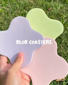 someone is holding three flower shaped coasters in their hand with the words blob coasters on them