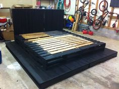 a bed frame made out of wood in a garage