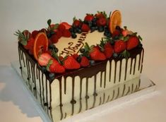 a cake with chocolate icing and fruit on top