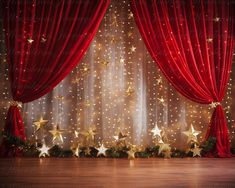 a red curtain with gold stars on it in front of a wooden floor and wall