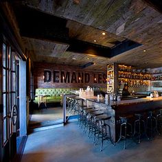 a bar with lots of stools in front of it