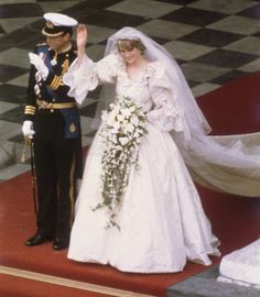 the bride and groom are walking down the red carpeted staircases at their wedding