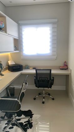 a home office with a cow hide rug on the floor and a window in the corner