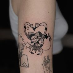 a tattoo on the arm of a woman with an arrow and heart in her hand