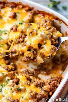 a spoon full of cheese covered ground beef casserole