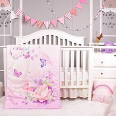 a baby's room with pink and purple decor