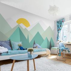 a bedroom with mountains painted on the wall and a desk in front of it,