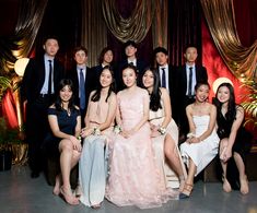 a group of people in formal wear posing for a photo