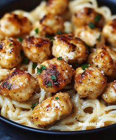 pasta with shrimp and parmesan cheese in a black bowl