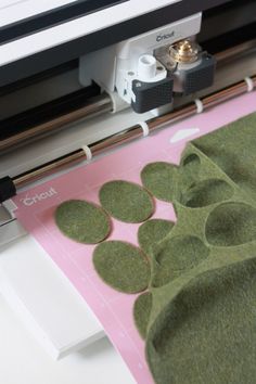 a close up of a machine cutting fabric