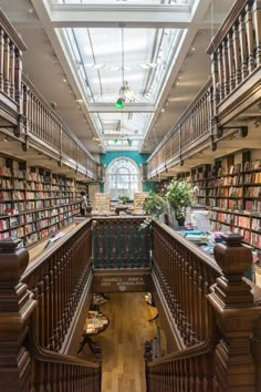 the inside of a library with many bookshelves and wooden railings on both sides