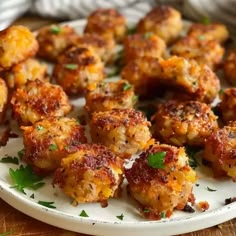 a plate full of meatballs with parsley on top