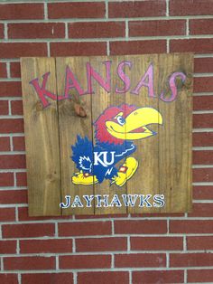 the kansas jayhawks sign is painted on a brick wall