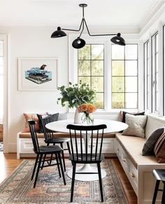 a living room filled with lots of furniture next to a dining table and couches