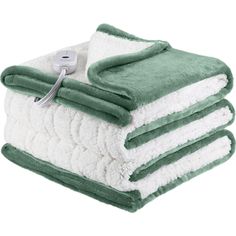 three towels stacked on top of each other with a thermometer attached to them