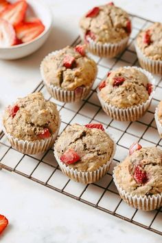 muffins cooling on a wire rack with strawberries