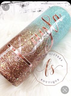 a blue and gold glitter tumbler with the word sister on it