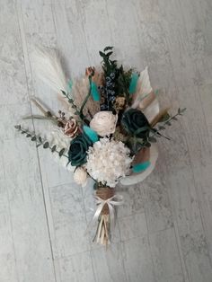 an arrangement of flowers and feathers on the floor