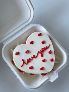 a heart shaped cake in a plastic container