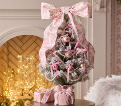 a decorated christmas tree with pink bows and ornaments