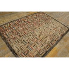 an old rug is laying on the floor in front of a wooden flooring area