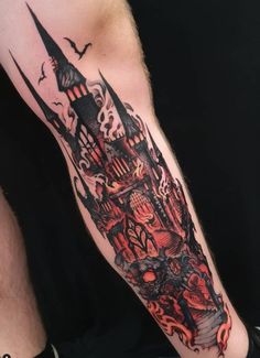 a man with a tattoo on his arm that has an image of a castle in it