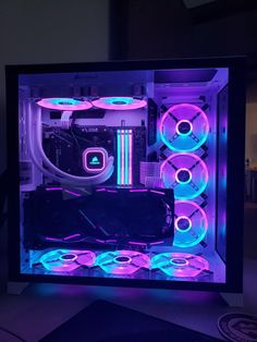 the inside of a computer case with purple and blue lights on it's sides