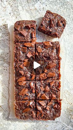 chocolate brownies cut into squares on top of parchment paper