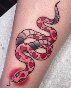 a red and black snake tattoo on the leg