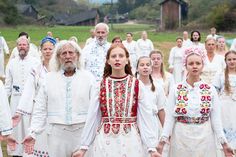 a group of people dressed in white and red